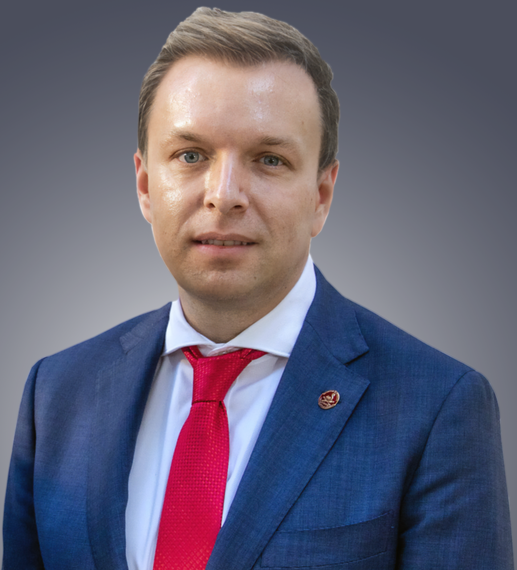 Close-up shot of Peter, wearing blue suit and red tie.